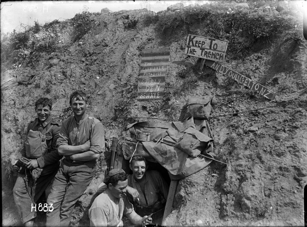 New Zealanders having a laugh - the sign reads 'The Cannibals Paradise Supply Den Beware'. Gommecourt Wood, 10 August 1918.